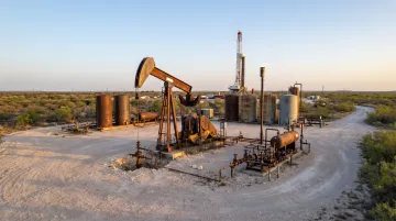 Oil and natural gas drilling site with active production equipment