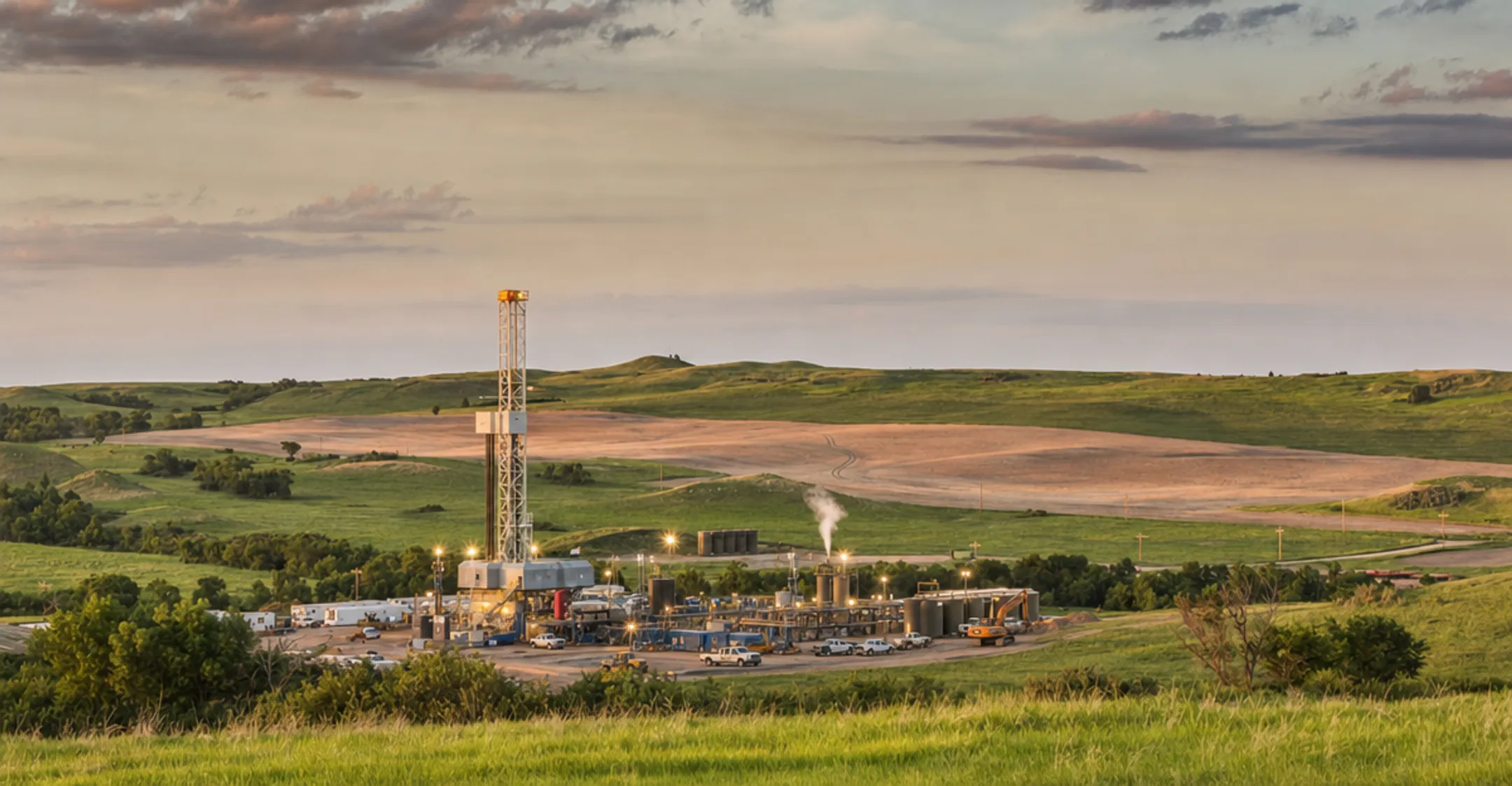 Natural gas drilling site with active equipment in rural Texas basin