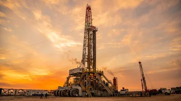 Active drilling rig operating in East Texas gas field at dusk
