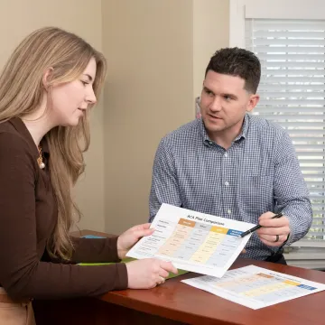 Advisor explaining health plan choices to a client