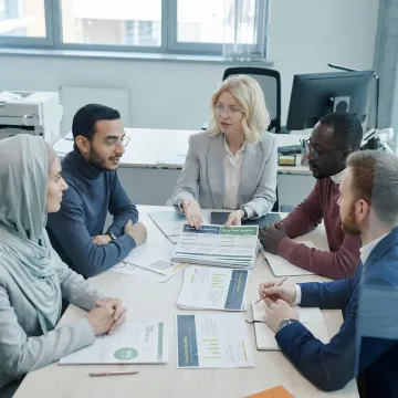 Advisor explaining disability benefit options to a small business team