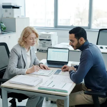 HR professional assisting nonprofit employee with benefits