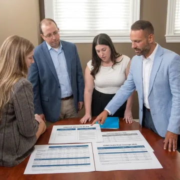 Advisor helping employer compare health benefit options
