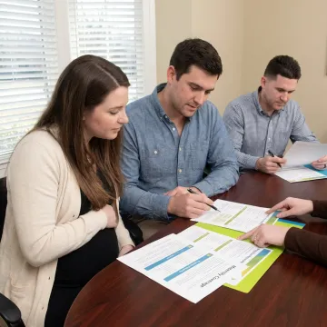 Advisor explaining maternity insurance benefits