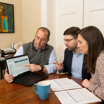 Advisor explaining health plan choices to a couple