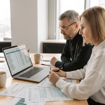 Small business owner reviewing payroll documents