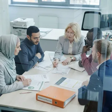 Advisor discussing retirement benefits with a business team