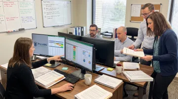 Credit union compliance team reviewing member risk profiles and data