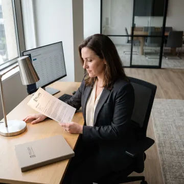 Compliance advisor reviewing AML monitoring data