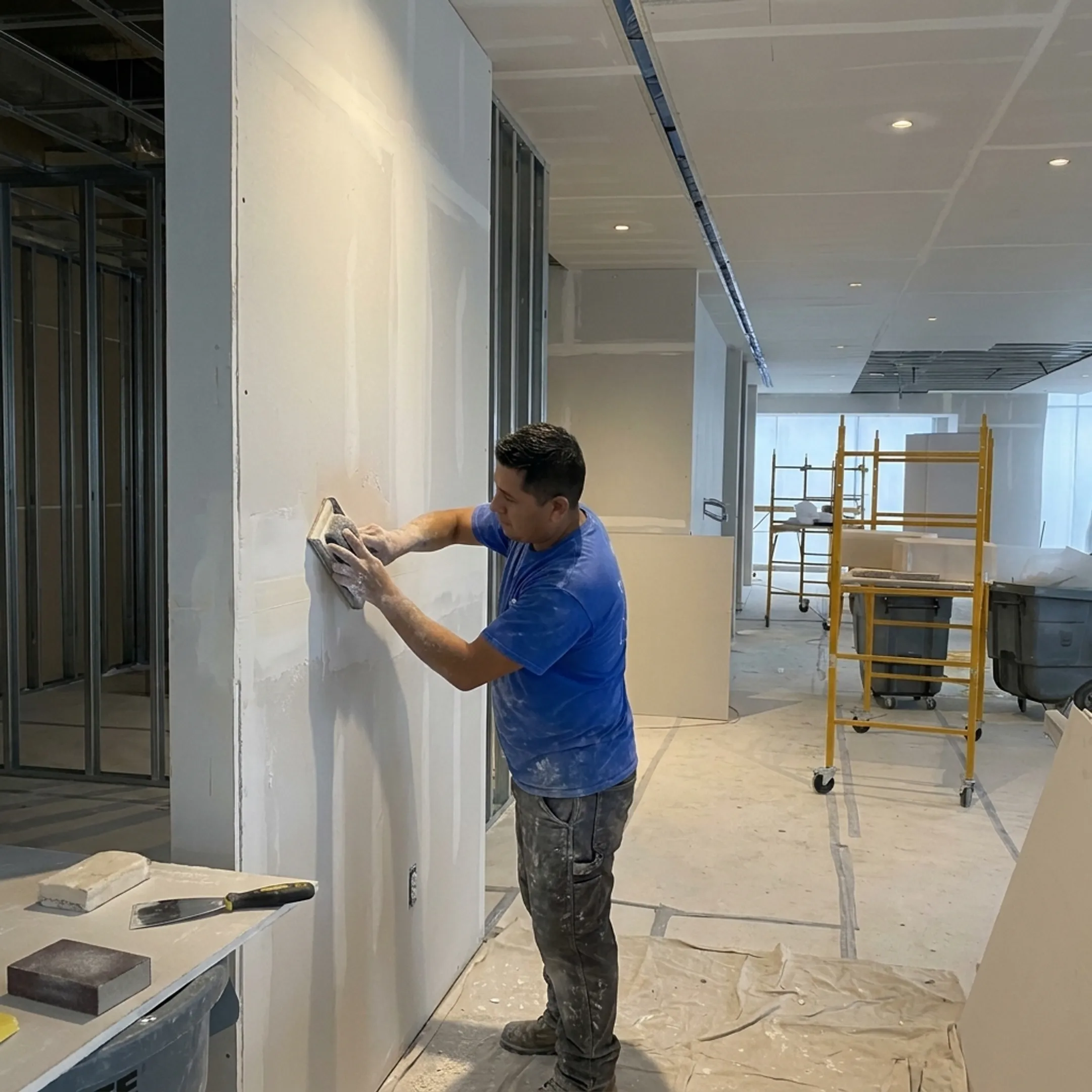 Smooth repaired drywall wall before painting