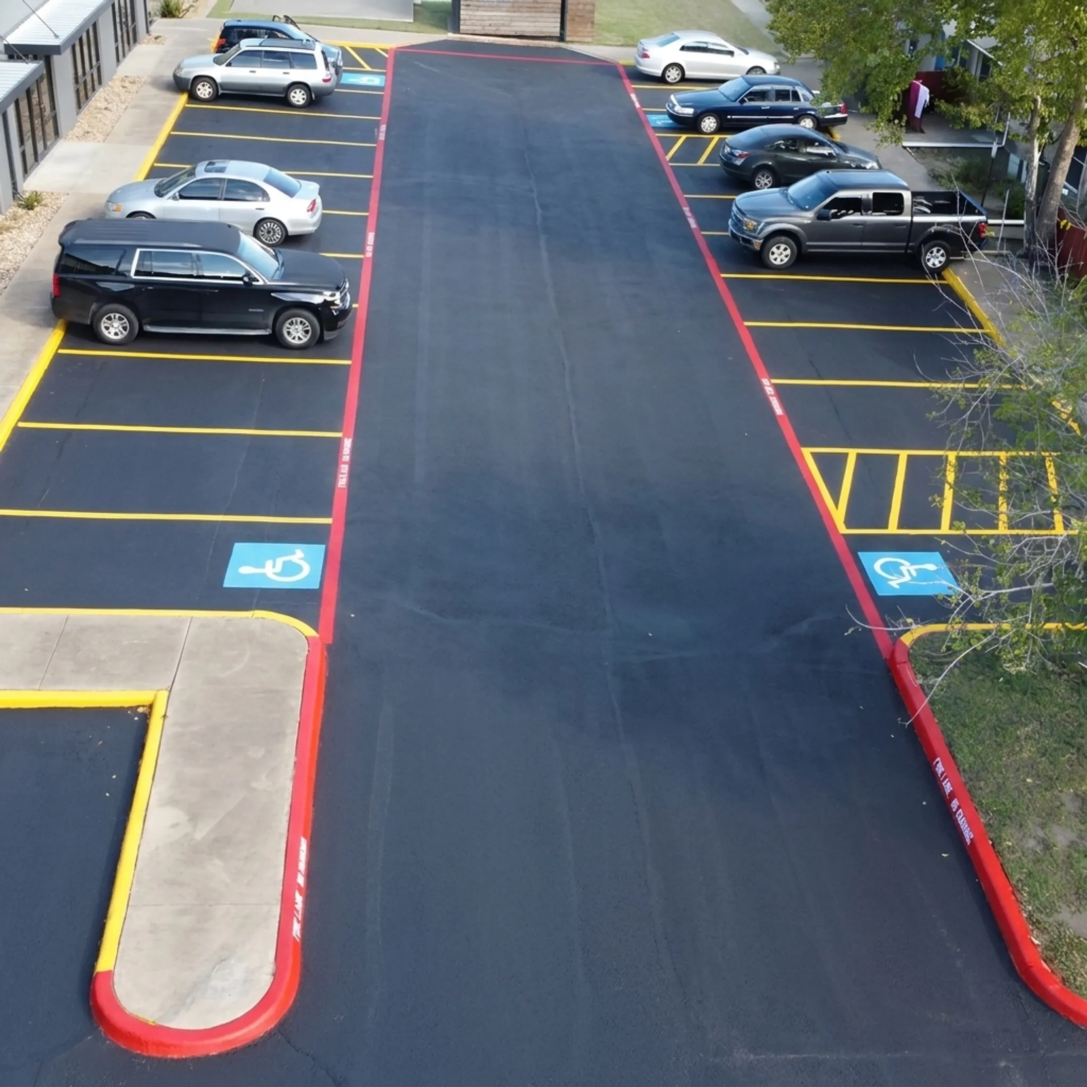 Crew applying fresh striping to a commercial parking lot