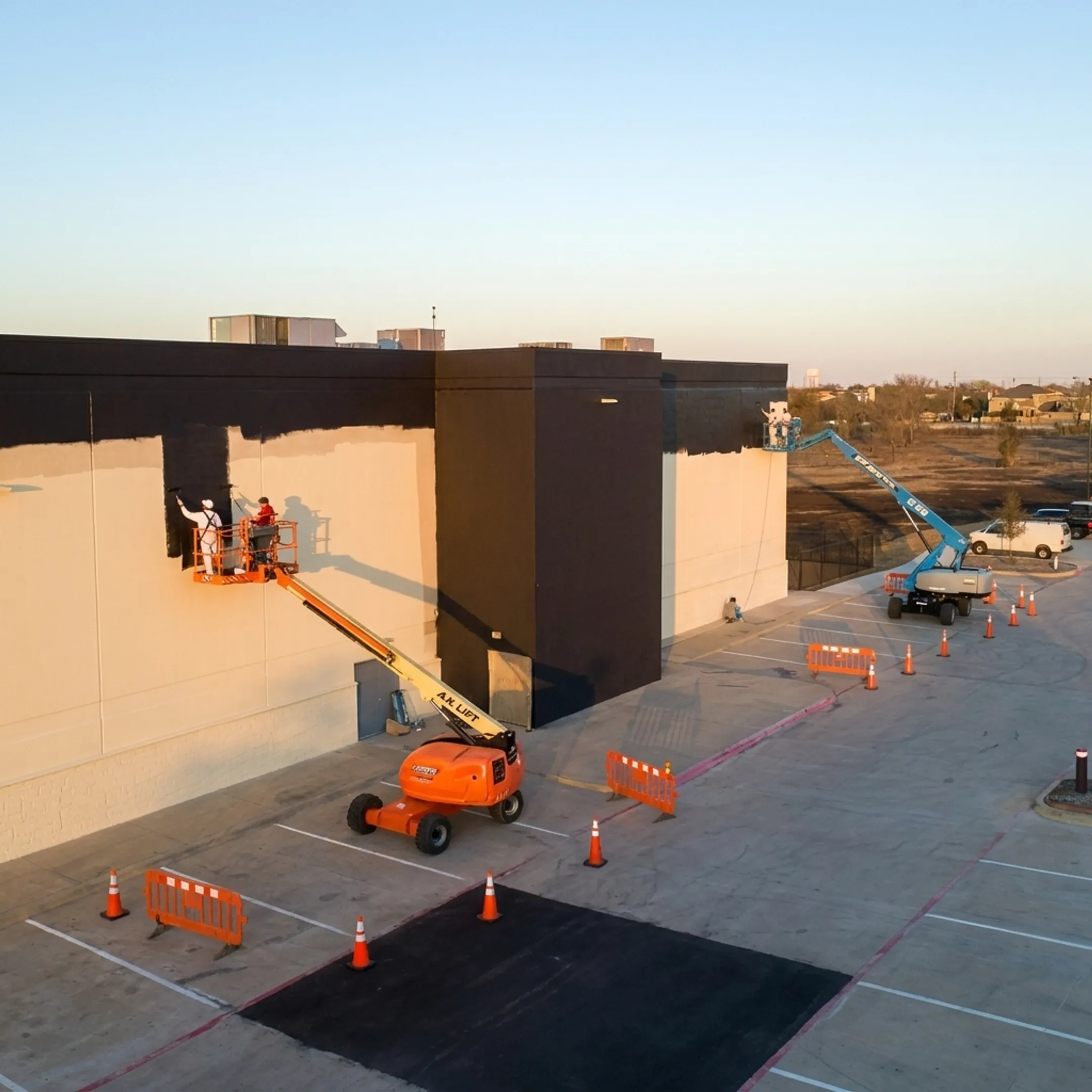Commercial crew improving a building exterior and parking lot