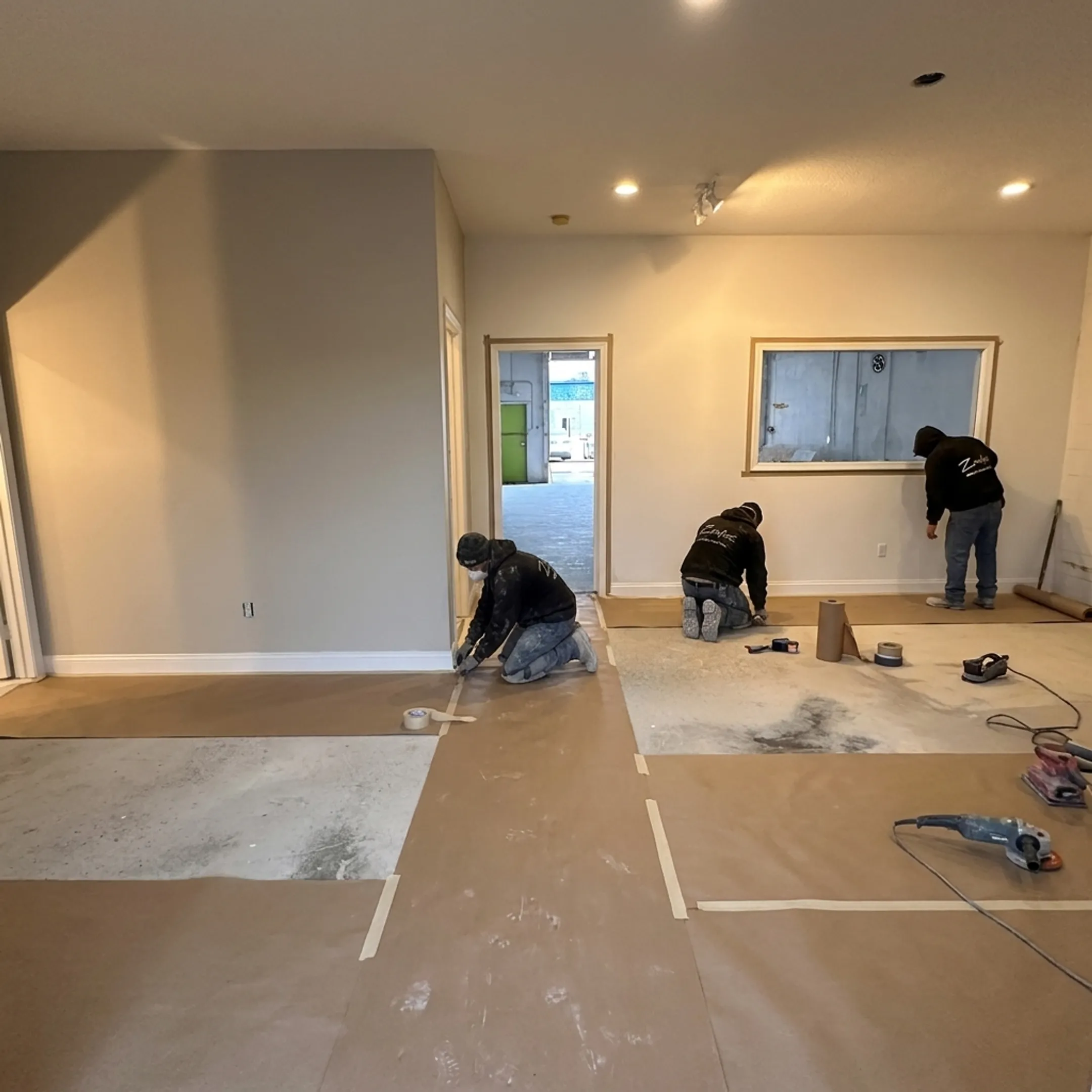 Commercial painting crew preparing an office wall