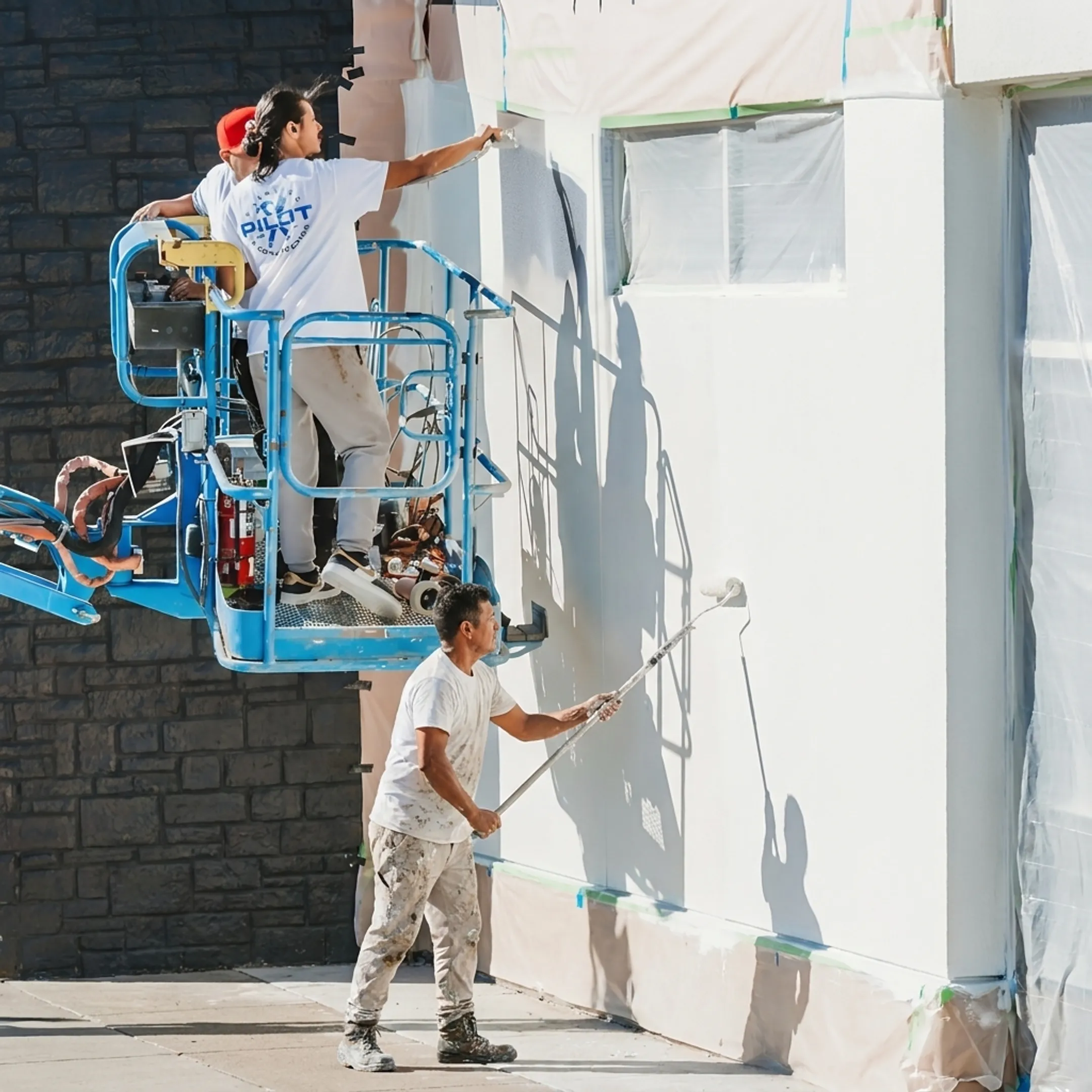 Painter finishing a commercial storefront exterior
