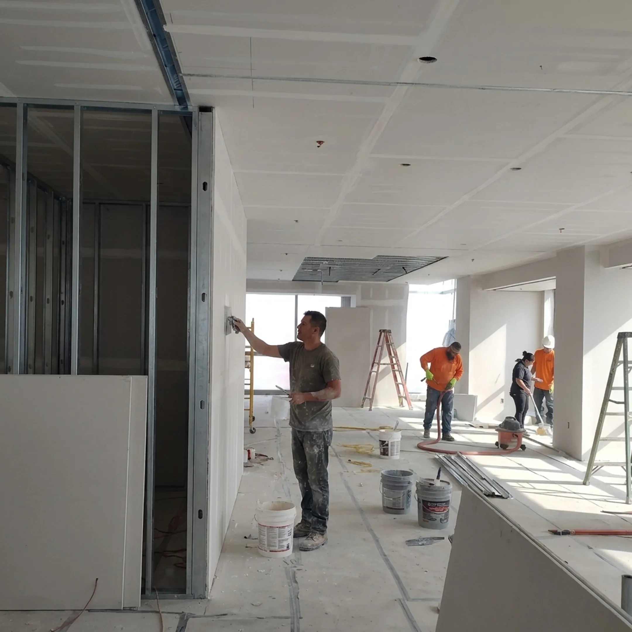 Commercial contractor finishing drywall in an office