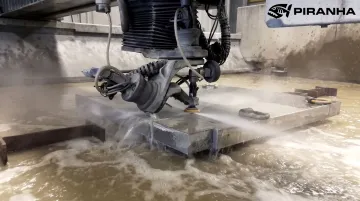 Industrial abrasive waterjet cutting thick metal plate in shop
