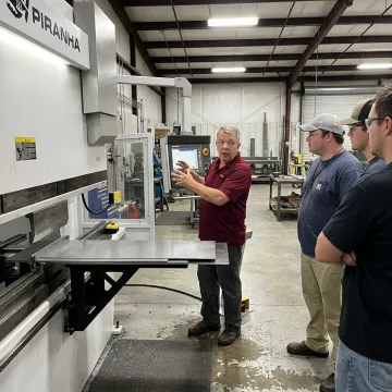 Instructor demonstrating sheet metal bending controls