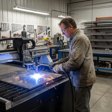 Fabricator operating a CNC plasma cutting system