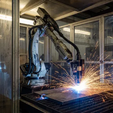 Robotic plasma cutter processing steel plate