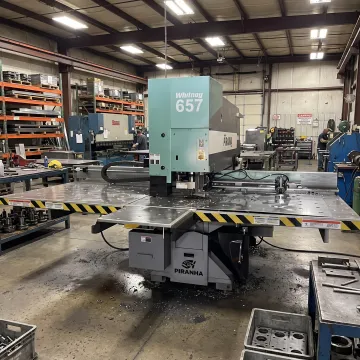 Industrial die punching machine in a metal fabrication shop