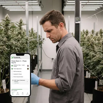 Cultivator using mobile task tracking app in grow room