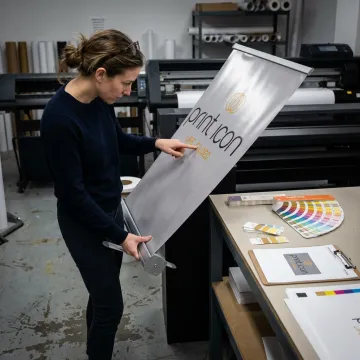 Designer reviewing retractable banner proof