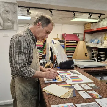 Print technician reviewing proofs