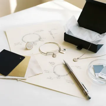 Custom branded jewelry pieces on a design table