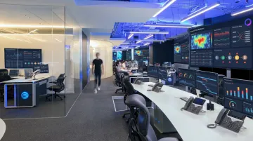 Financial fraud analyst reviewing AI-generated threat data on enterprise security dashboard