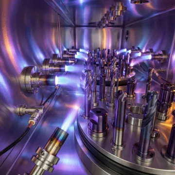 PVD coating chamber with titanium aluminum nitride deposition process in progress