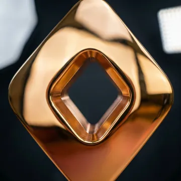 Close-up of polished brass component showing mirror finish quality