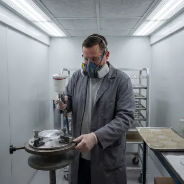 Industrial coating facility with UV curing equipment for polycarbonate lenses