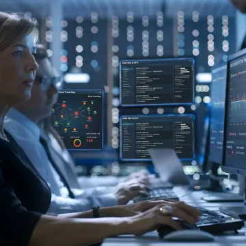 Threat intelligence analysts monitoring cyber risks