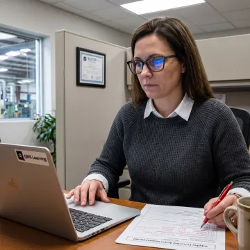 Quality professional reviewing supplier audit records