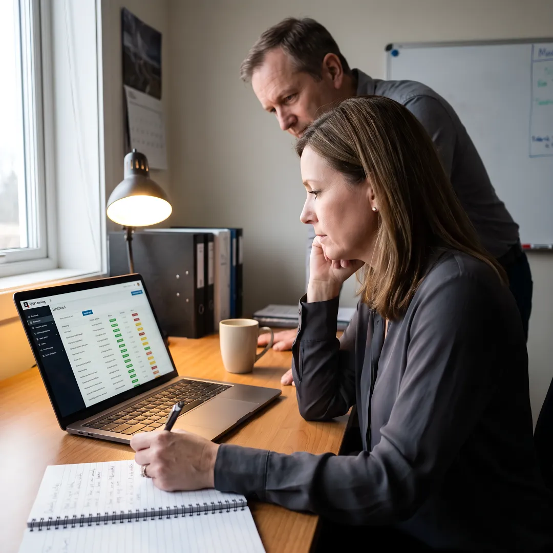 Manufacturing team reviewing online compliance training dashboard