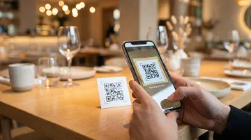 Restaurant table QR code menu scanning on smartphone in dining setting