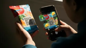 Consumer scanning QR code on product packaging with augmented reality experience displayed on smartphone