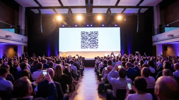 Event attendees scanning QR code displayed on large venue screen