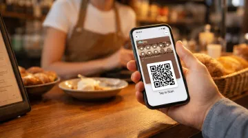 Mobile phone displaying digital stamp card loyalty app with QR code scanner