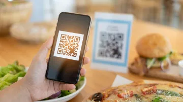 Restaurant diner scanning table QR code for contactless payment checkout experience