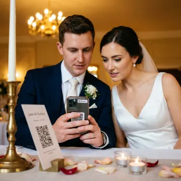 Couple scanning a wedding QR code