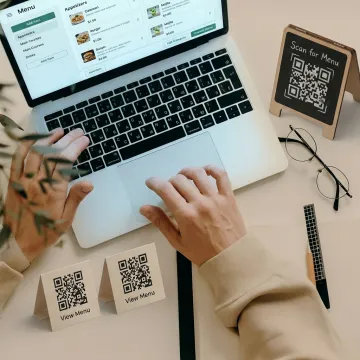 Staff updating a restaurant QR menu board