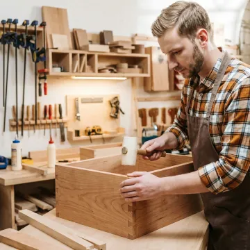 Craftsman building custom bathroom vanity in workshop