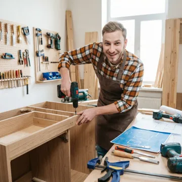 DIY builder constructing custom bathroom vanity in home workshop