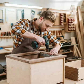 Craftsman building custom 24 inch bathroom vanity with precision tools