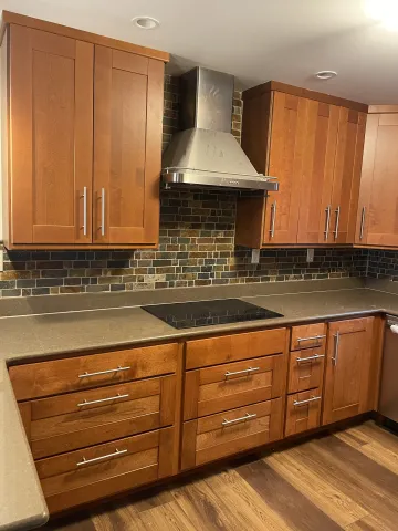 Cabinet maker measuring and installing custom plywood kitchen cabinets