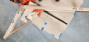 Cabinet maker measuring and crafting custom wood cabinets in a workshop
