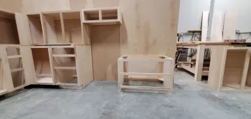 Restored kitchen cabinets with new hardware and refinished surfaces