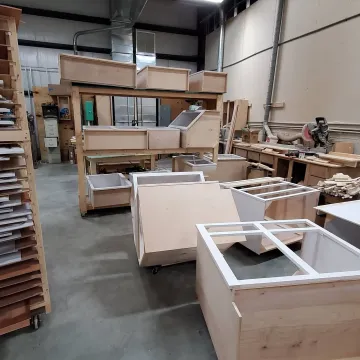 Cabinet maker measuring and installing custom kitchen cabinets in a Pennsylvania home