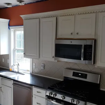 Step-by-step kitchen cabinet refinishing process from sanding to final finish